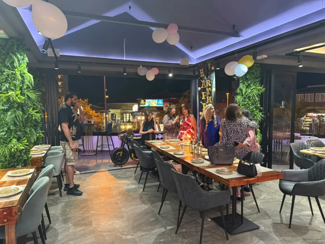 Guests gathered around a dining table with birthday balloons at Monsoon Tenerife